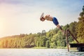 Young fit man jumping into a lake Royalty Free Stock Photo