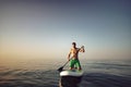Young fit man on paddle board floating on lake. Royalty Free Stock Photo