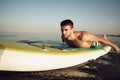 Young fit man on paddle board floating on lake. Royalty Free Stock Photo