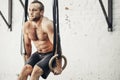 Fit man pulling up on gymnastic rings. Royalty Free Stock Photo