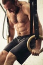 Fit man pulling up on gymnastic rings. Royalty Free Stock Photo