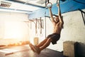 Fit man pulling up on gymnastic rings. Royalty Free Stock Photo