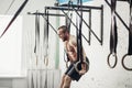 Fit man pulling up on gymnastic rings. Royalty Free Stock Photo