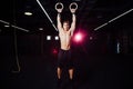 Young fit man pulling up on gymnastic rings. Royalty Free Stock Photo