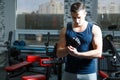 Young fit man putting his gloves, preparing for training