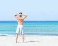 Young, fit man standing on a summer beach Royalty Free Stock Photo