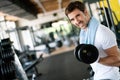 Young fit man with weight training equipment on sport gym club Royalty Free Stock Photo