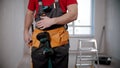 A young fit man worker wearing a tool belt Royalty Free Stock Photo
