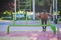 Young fit shirtless black man doing push-ups on parallel bars. Royalty Free Stock Photo