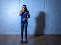 Young thin fit girl on scale obsessed with weight gain feeling fat and desperate Royalty Free Stock Photo