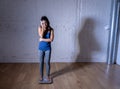 Young thin fit girl on scale obsessed with weight gain feeling fat and desperate Royalty Free Stock Photo