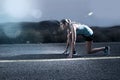 Young fit sport woman running outdoors on asphalt road in mountain landscape and dramatic light set for advertising Royalty Free Stock Photo