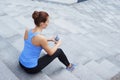 Young, fit and sporty woman resting after the training. Fitness, sport, urban jogging and healthy lifestyle concept. Royalty Free Stock Photo