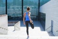 Young, fit and sporty girl running up the stairs. Fitness, sport, urban jogging and healthy lifestyle concept.