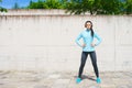 Young, fit and sporty girl in the street. Fitness, sport, urban jogging and healthy lifestyle concept. Royalty Free Stock Photo