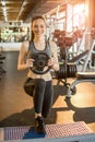 Young fit sporty woman doing triceps dips over stepper platform in gym. Royalty Free Stock Photo