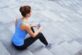 Young, fit and sporty woman resting after the training. Fitness, sport, urban jogging, healthy lifestyle concept. Royalty Free Stock Photo