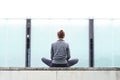 Young, fit and sporty girl sitting on a concrete border. Fitness, sport, urban jogging and healthy lifestyle concept. Royalty Free Stock Photo