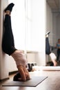 Young fit woman doing handstand exercise in gym Royalty Free Stock Photo