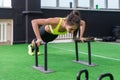 Young fit woman doing horizontal push-ups with bars in gym. Royalty Free Stock Photo