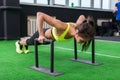 Young fit woman doing horizontal push-ups with bars in gym. Royalty Free Stock Photo