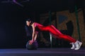 Young fit woman doing push up or plank exercise on medicine ball at gym Royalty Free Stock Photo