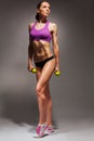 Young fit woman with dumbbells exercise