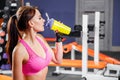 Young fit woman with energy drink relaxing and drinking in the gym. Sport and fittness concept Royalty Free Stock Photo