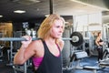 Young fit woman at the gym doing heavylifting exercise. Female a Royalty Free Stock Photo