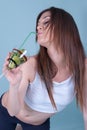 Young fit woman holding a glass with kiwi pieces
