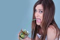 Young fit woman holding a glass with kiwi pieces