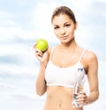 Young and fit woman holding a green apple