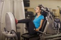 Young fit woman leg press in a fitness center. Portrait of fitness girl in the gym, lifestyle concept.. Royalty Free Stock Photo