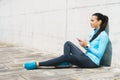 Young and fit woman listening to the music outdoor. Royalty Free Stock Photo