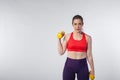 Young fit woman posing with yellow dumbbells Royalty Free Stock Photo