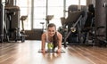 Young fit woman practicing the forearm plank exercise for core s