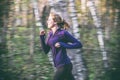 Female jogger in nature forest trail. Motion blur. Royalty Free Stock Photo