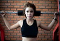 Young fitness asian woman exercise with machine Cable Crossover Royalty Free Stock Photo