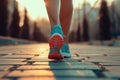 Young fitness female runner legs ready for run on a city road