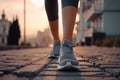 Young fitness female runner legs ready for run on a street