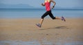 female runner running at beach Royalty Free Stock Photo