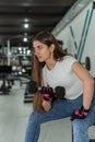 Young fitness female trainer doing exercise and lifting dumbbells weights gym Royalty Free Stock Photo