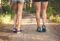 Young fitness girl legs at forest trail at sunset. Sporty women