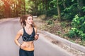 Young fitness girl running and listening music in the park Royalty Free Stock Photo