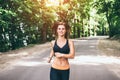 Young fitness girl running and listening music in the park Royalty Free Stock Photo