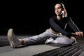 Young fitness girl stretching her legs on the mat in the gym isolated on black Royalty Free Stock Photo