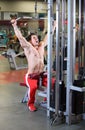 Young fitness guy working out on exercise machine Royalty Free Stock Photo