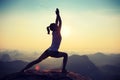 Fitness woman meditating on sunrise mountain peak Royalty Free Stock Photo