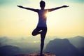 Fitness woman meditating on sunrise mountain peak Royalty Free Stock Photo