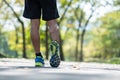 young fitness man legs walking in the park outdoor, male runner running on the road outside, asian athlete jogging and exercise on Royalty Free Stock Photo